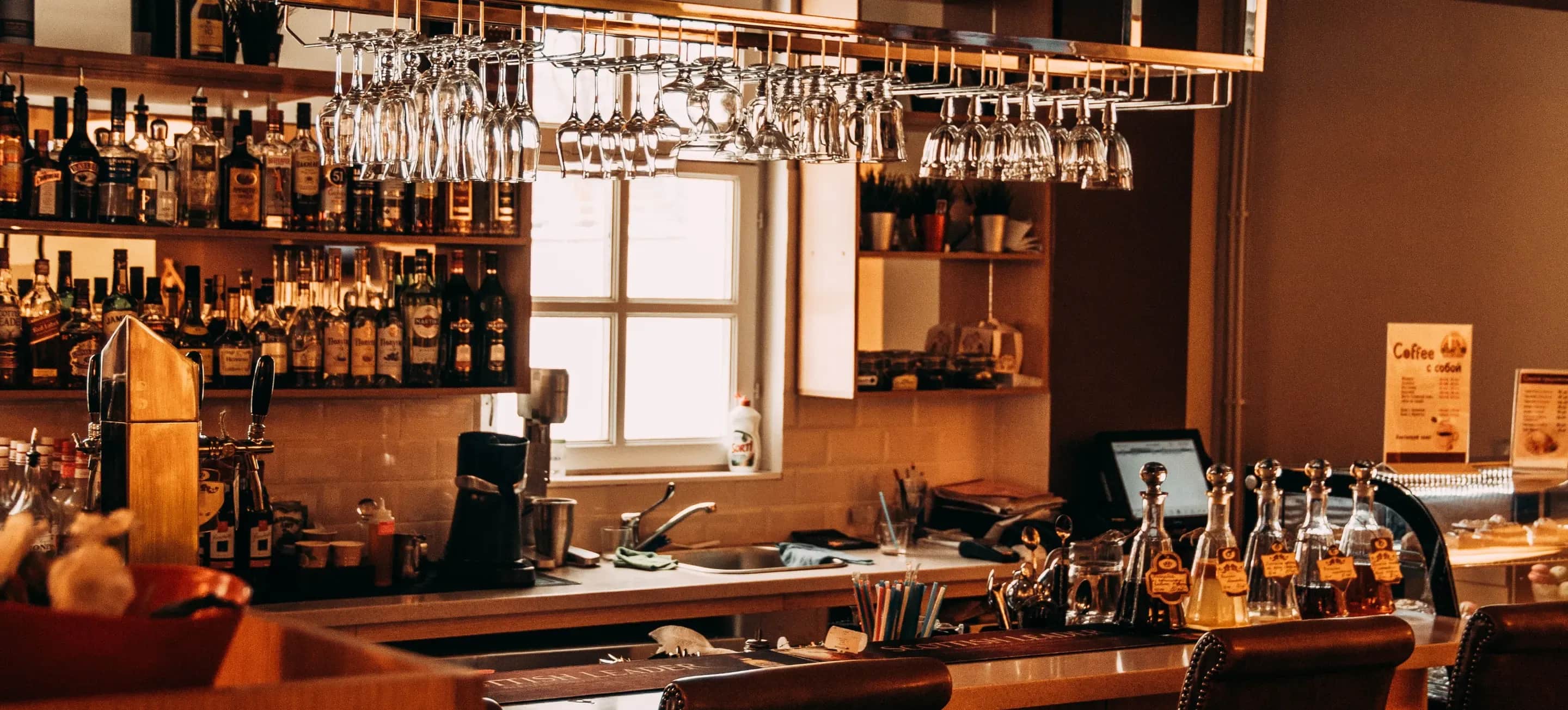 Bartender pouring a drink for patrons at a tavern